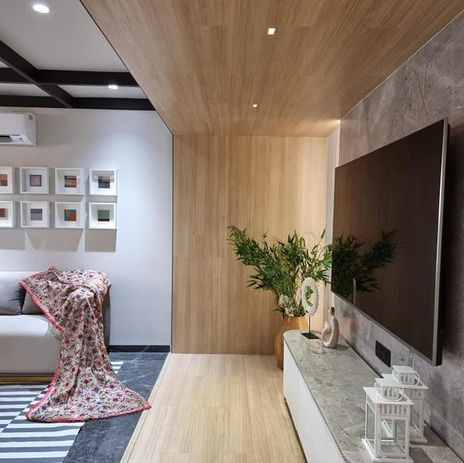 Modern living room with TV, sofa, decor and artwork. The Concept Hub