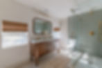 Walk-in shower and historic vanity with beautiful green tile in cottage core rental in Cincinnati.