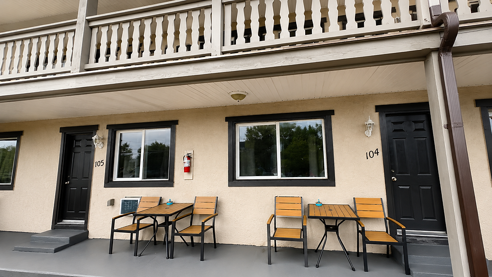 Motel facade with balcony and seating.png