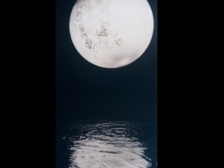 Full Moon in Cancer glowing over calm water, representing lunar energy for manifestation and success 🌕✨