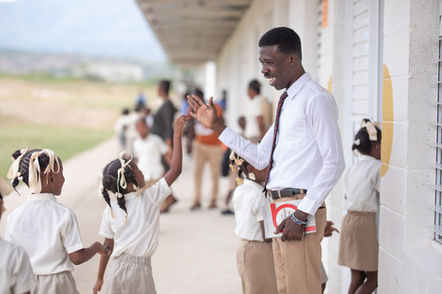 Teacher giving high-five to students