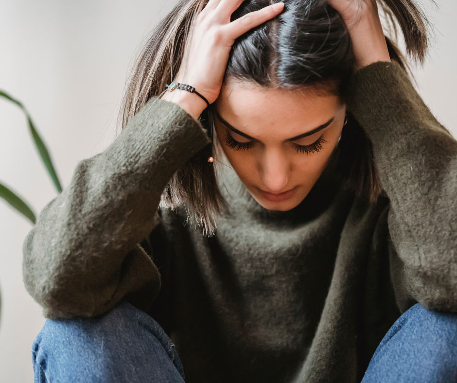 Woman holding her head in disappointment, find hope with Christian counseling in 60637.