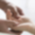 A healer holding the hands of someone who is receiving treatment