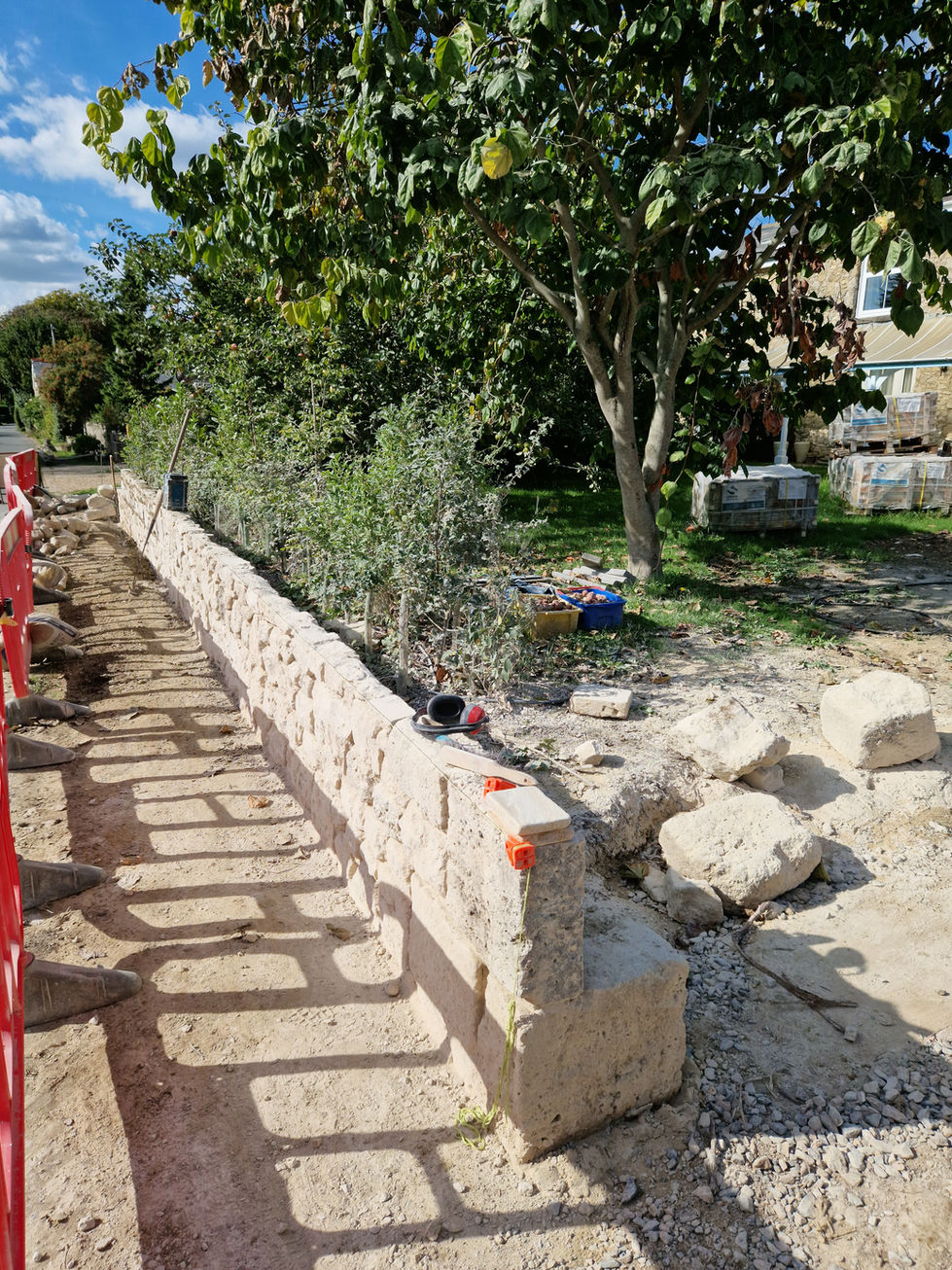 During - Short boundary wall in reclaimed limestone.
