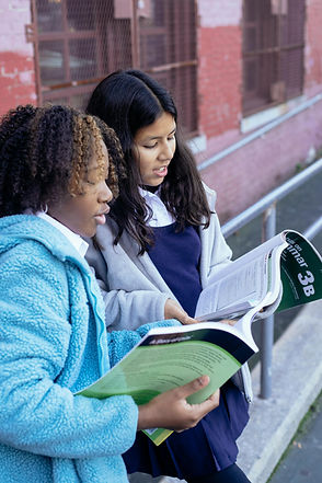 Two girls studying books together