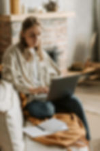 Woman typing on laptop at home
