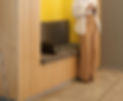 An African American woman standing in front of a banquette in a co working sapce.