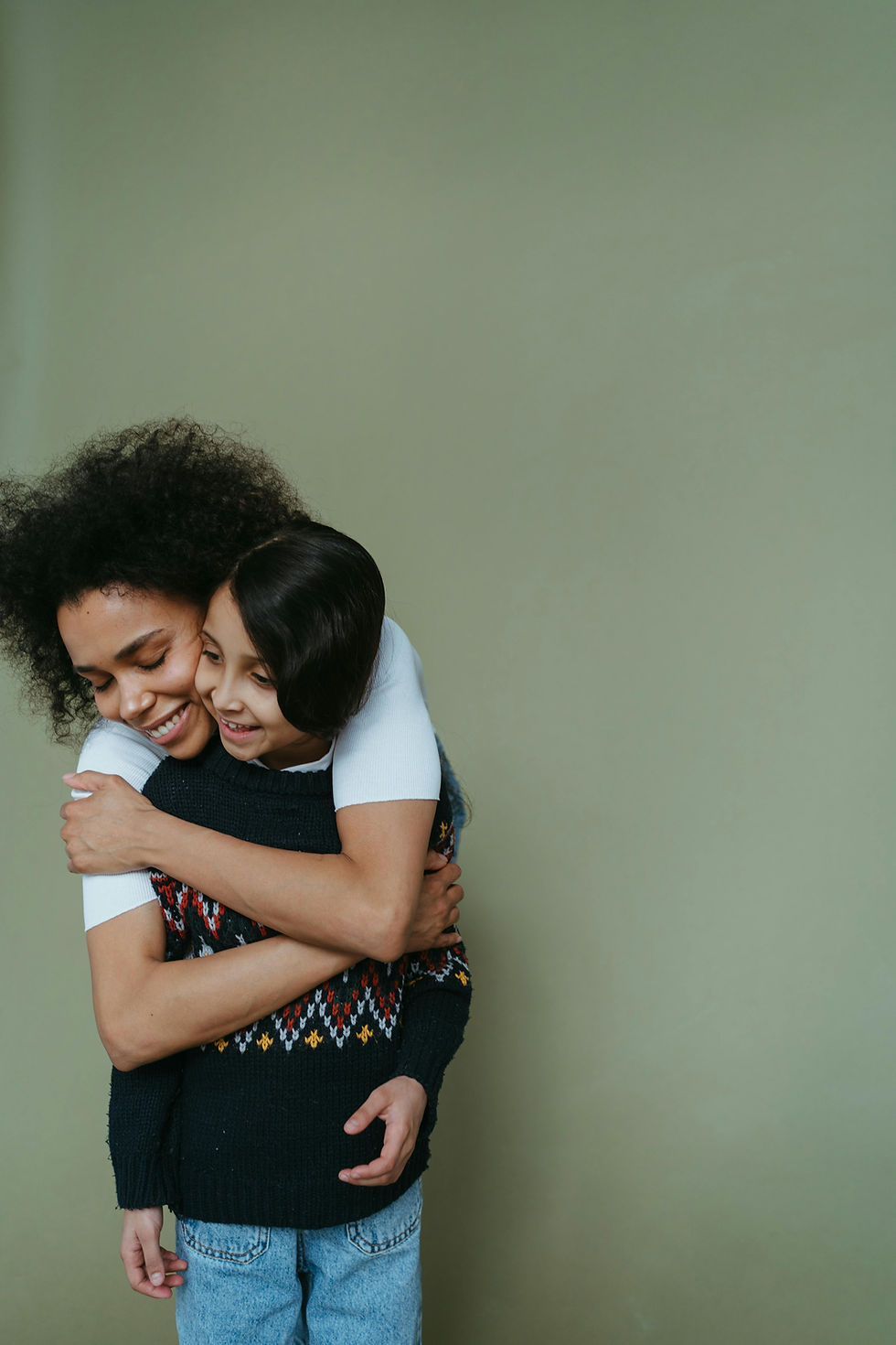 Woman giving child a piggyback ride, both smiling