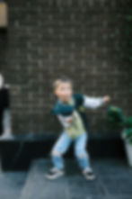 Energetic boy in ripped jeans makes a funny face