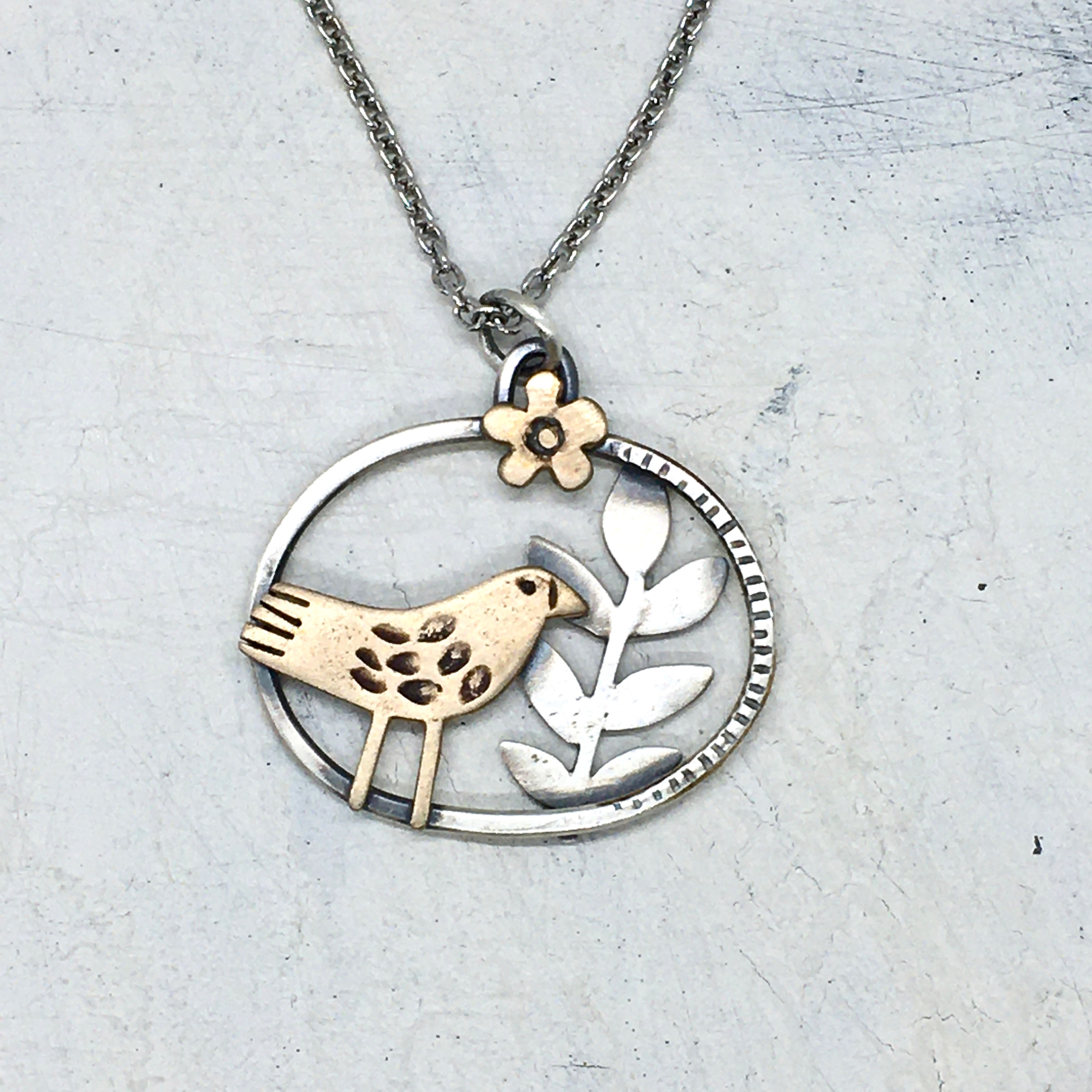 Bronze bird and silver leaf pendant
