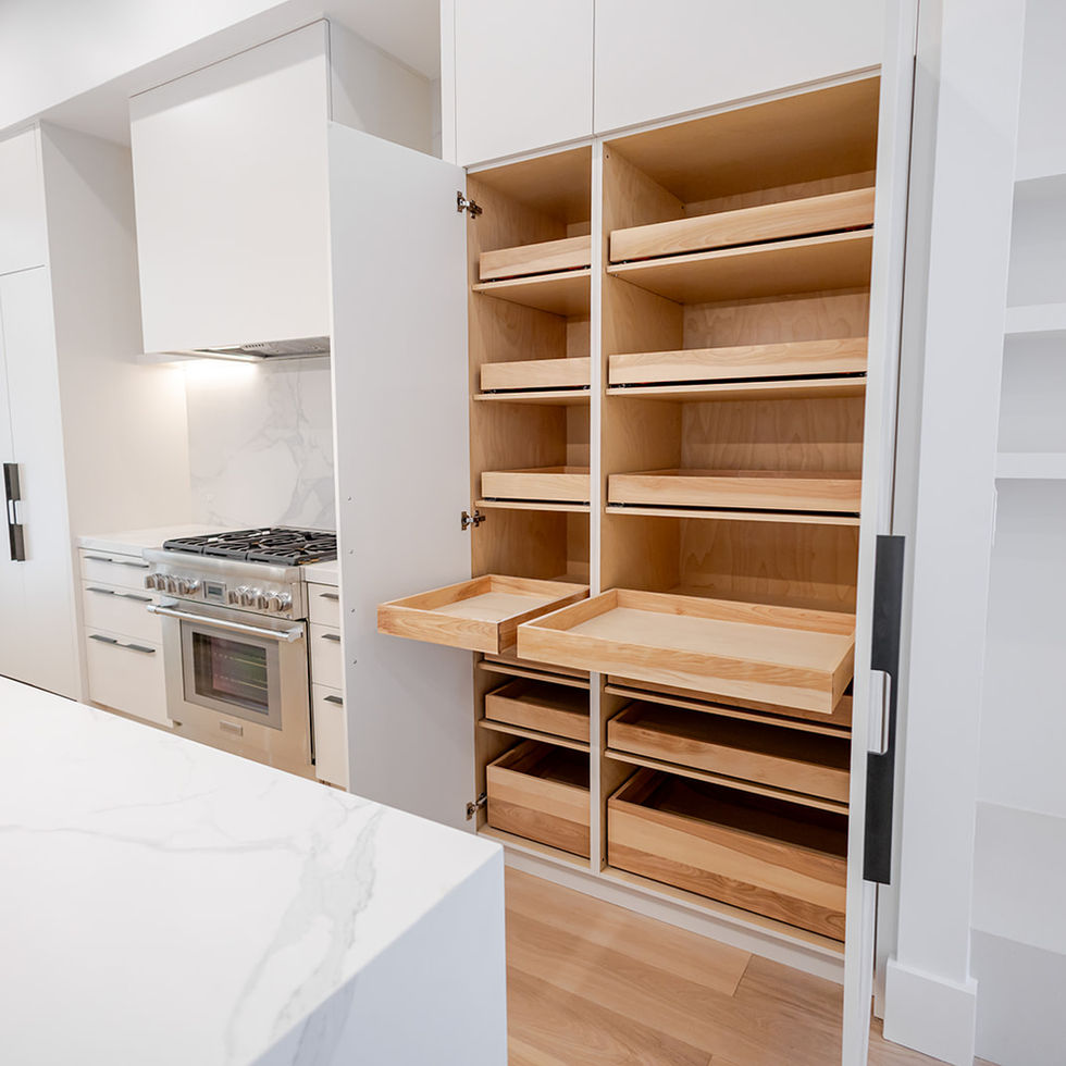 Open custom pantry cabinet with warm wood shelving and integrated storage beside the kitchen