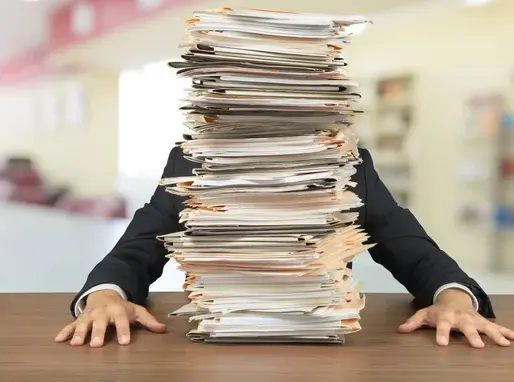 A businessman with a stack of work blocking his view - symobolising portfolios that scale load, not value