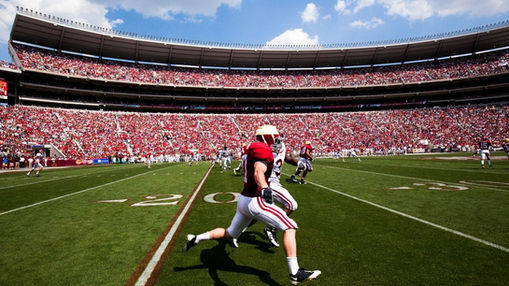Alabama US college football game with players moving in their trained system.