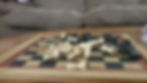 A chessboard with several pieces lying on their sides, suggesting a breakdown in strategy or a chaotic, unresolved game.