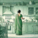 A middle-aged woman wearing a traditional Indian saree, viewed from the back, standing in