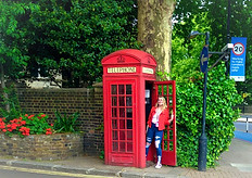 me hanging out of a red telephone box in England