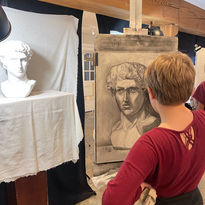 Teenager creates in classical drawing class.