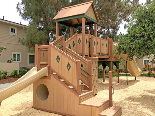 Wood play fort with crawl tube and slide