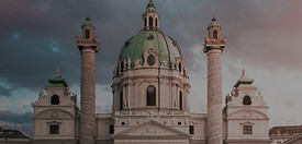 Vienna church reflection during sunset._