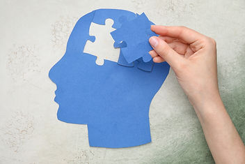 Paper outline of head with puzzle piece taken out