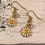 Thumbnail: Daisy flower charm gold earrings