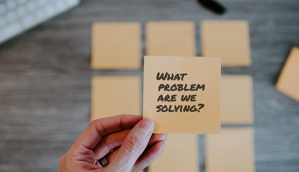 A post it note that says 'what problem are we solving'