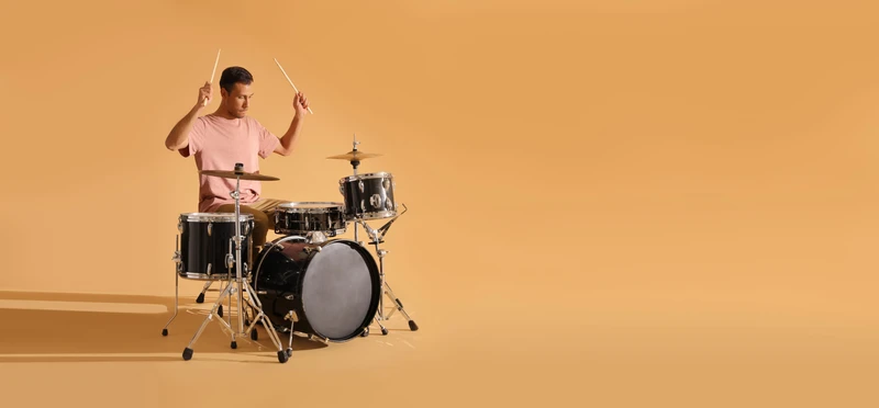 Productivity Crash Course a man playing a drum set with a drum stick