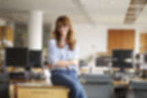Woman Sitting on Desk