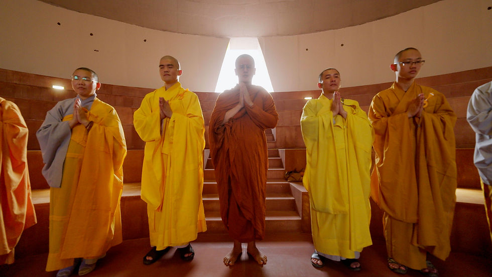Monks in robes with hands joined