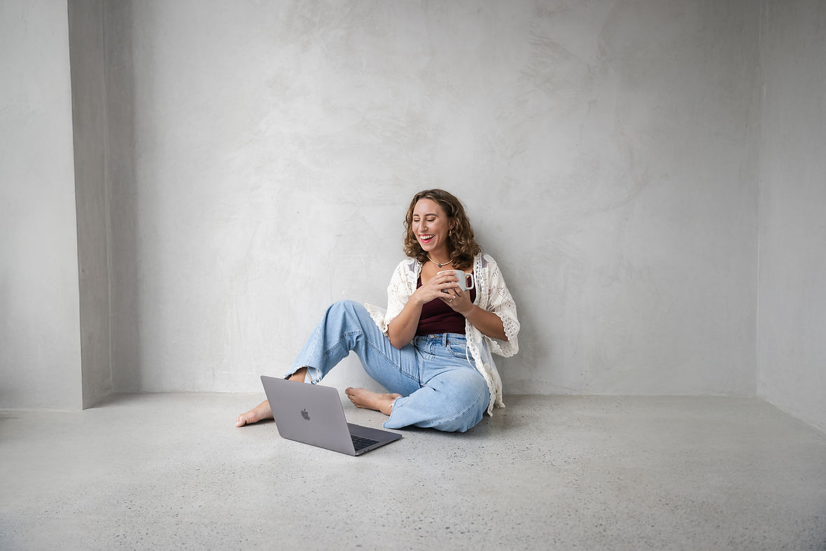 women's health coach chatting to an online client on her laptop