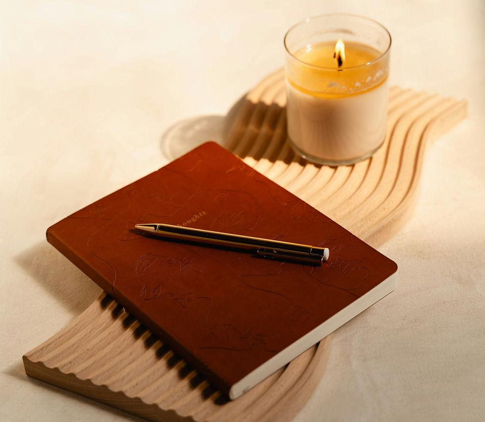 Photo of a journal, pen and candle on tray, courtesy of Mushaboom Studio for Unsplash