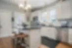 Staged farmhouse kitchen with off-white cabinets and minimal decorative items for a clean, inviting