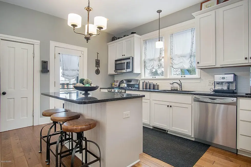 Staged farmhouse kitchen with off-white cabinets and minimal decorative items for a clean, inviting 