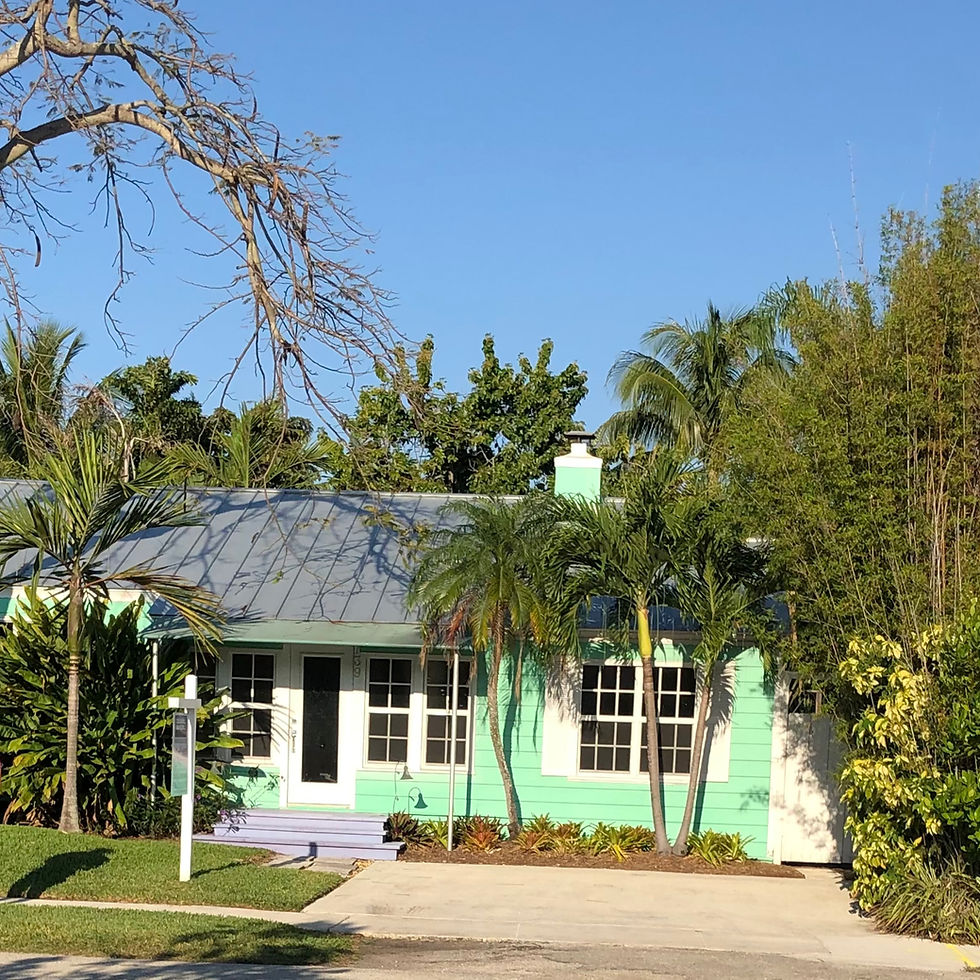 Key West style house with clean, inviting landscaping