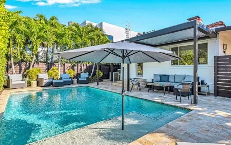 Poolside seating and umbrella on a sunny day