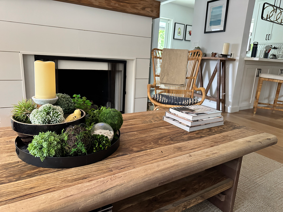 Spring vignette with mixed greenery, and a candle