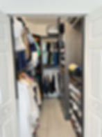 Shared closet organized to fit both partners’ clothing and all luggage, using a custom system to max