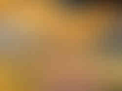 Abstract orange and gold streaks across dark textured surface resembling solar flare patterns