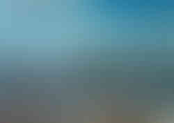 Linear streaks of turquoise cut across a textured field, their directional paths sharply defined against the darker layers beneath. The contrast between the cool, luminous lines and the deeper ground creates a sense of movement, as if the surface has been marked by passing energy. Each streak introduces a sense of direction, guiding the eye across the composition with purposeful motion.
The underlying surface remains dense and varied, with subtle textures and tonal shifts that give depth to the image. Where the turquoise lines intersect with darker areas, a layered interaction emerges—suggesting both disruption and integration. The composition feels shaped by forces in motion, where the surface records the passage of elements rather than remaining static.
There is a sense of velocity within the image, where movement feels immediate and continuous. The streaks evoke wind-driven patterns or fleeting currents, passing quickly through space and leaving a visible trace. The composition captures a moment of transition, where direction and energy define the structure of the surface.