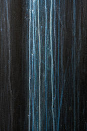 Dark Chemical container surface with vertical streaks of blue and white corrosion lines