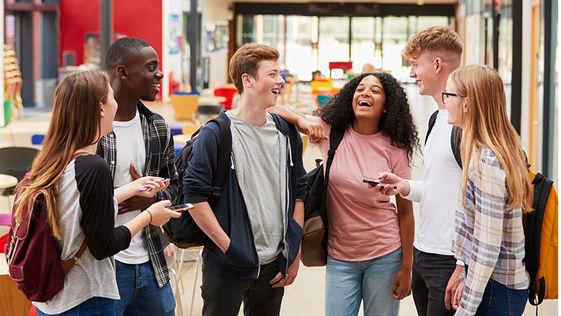 Students from diverse backgrounds interacting in a welcoming school environment.