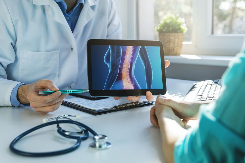 Doctor and patient talk about spine fusion