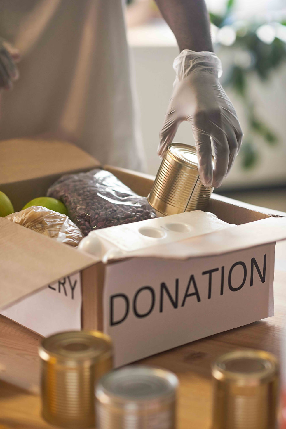 volunteering-adult-packs-donation-box-with-food-2026-01-09-00-42-39-utc.jpeg
