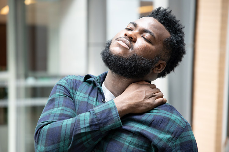 A man experiences nerve pain in his neck and shoulder