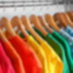 Rainbow coloured clothes on hangers