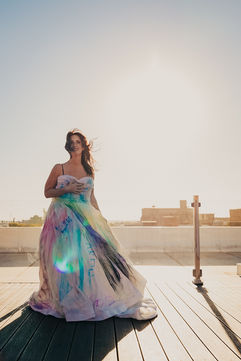 a woman wearing a colorful dress in the sunlight