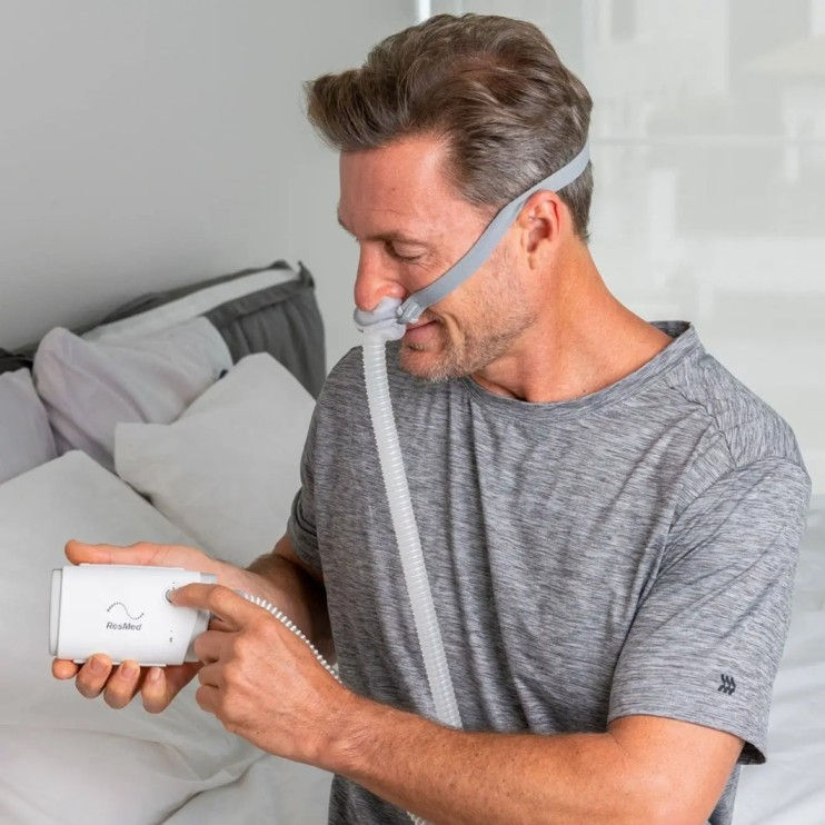 Thumbnail: Man Wearing ResMed AirMini P10 mask system with QuietAir vent technology