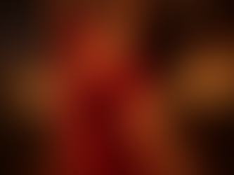 Namkeen is dancing in a red and gold outfit with candles in the background.