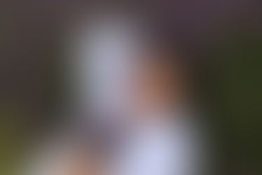 Adrian Kaleb Quijano is a queer, trans, Filipino writer and journalist - pictured here lying in a field of lavender.