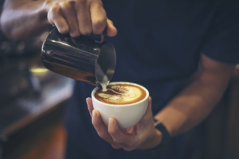 close-up-hands-barista-make-latte-coffee-art-paint-min.jpg